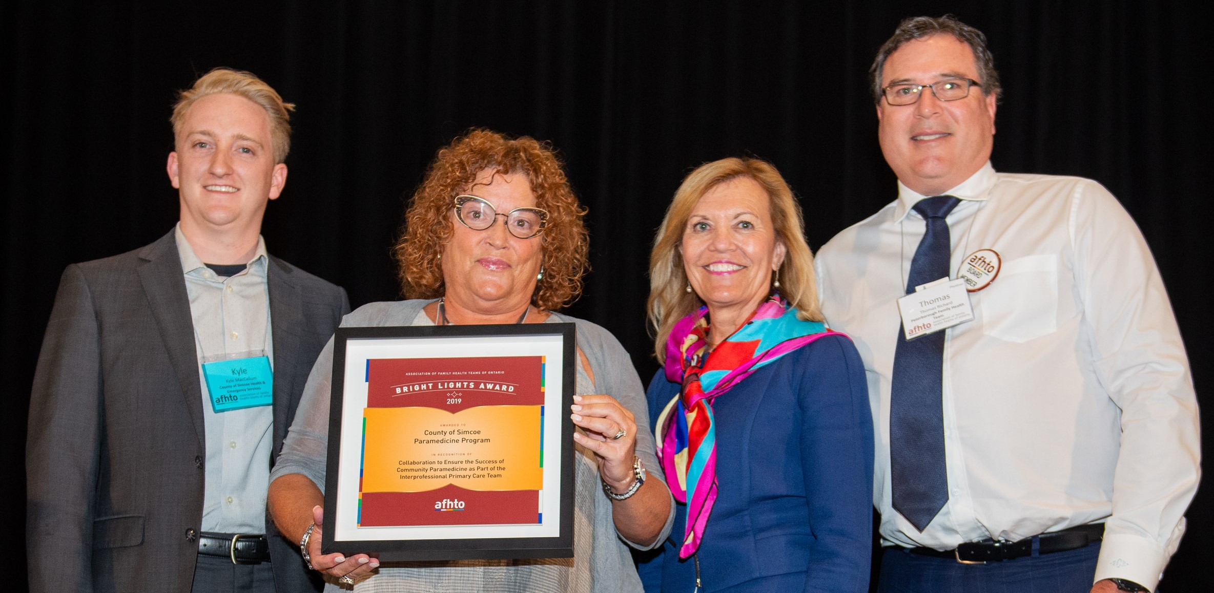 Merideth Morrison, Director, Performance, Quality & Development, Health & Emergency Services accepts the 2019 Board award with Kyle MacCallum on behalf of the County of Simcoe Community Paramedicine Program from Minister Hon. Christine Elliott and AFHTO president Dr. Thomas Richard