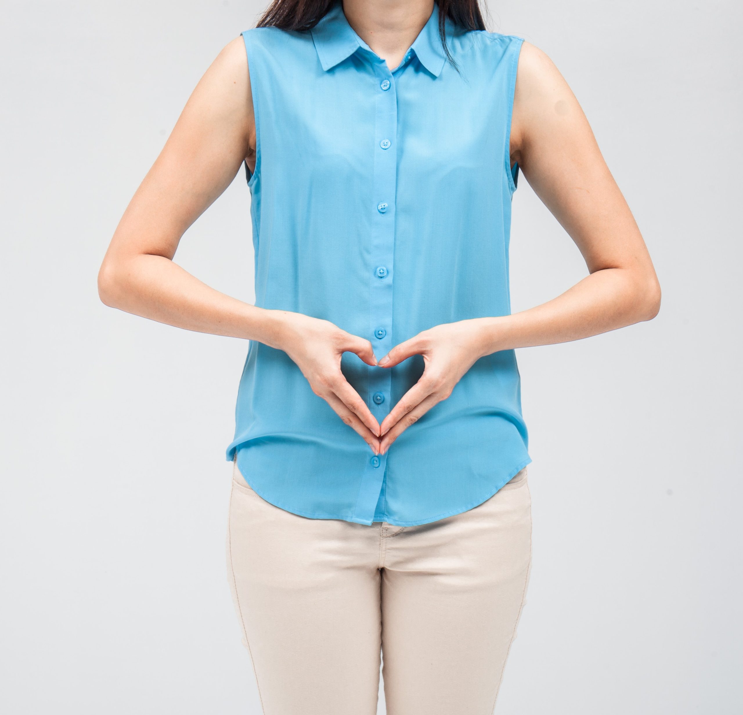 PSO Woman in blue shirt making heart on stomach